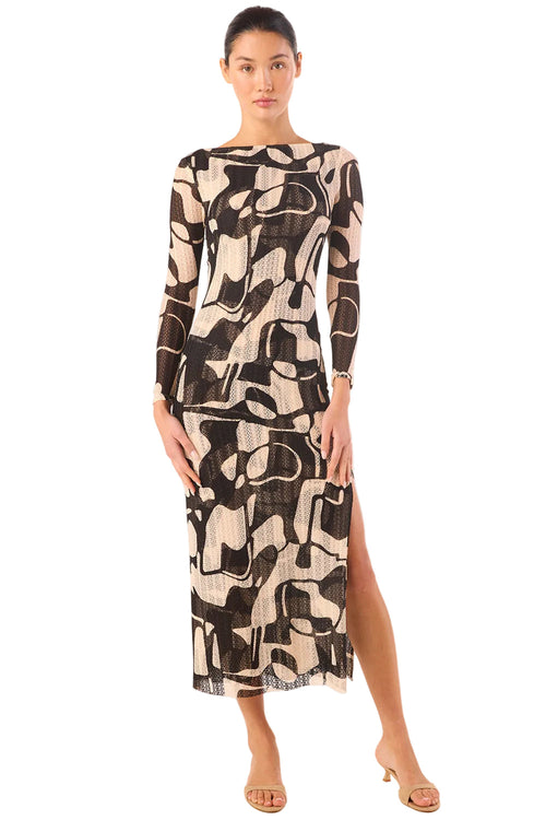 Model wearing a patterned dress on a white background