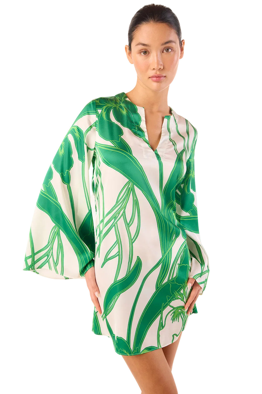 Woman wearing a green and white patterned dress on a white background