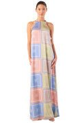 Woman wearing a long, patterned dress on a white background