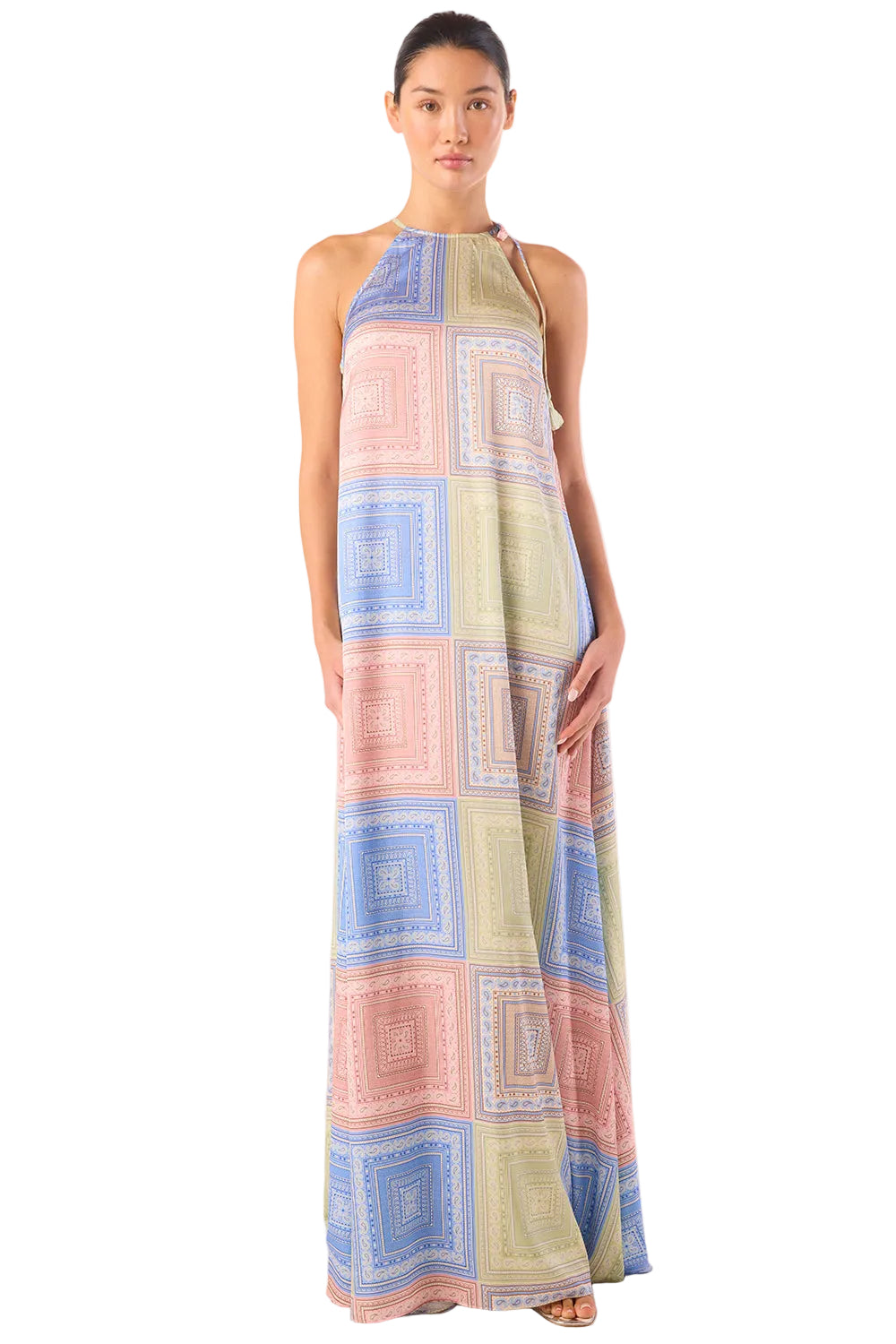 Woman wearing a long, patterned dress on a white background