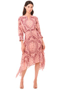 Woman wearing a pink patterned dress on a beige background