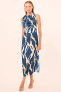 Woman wearing a blue and white patterned dress on a beige background