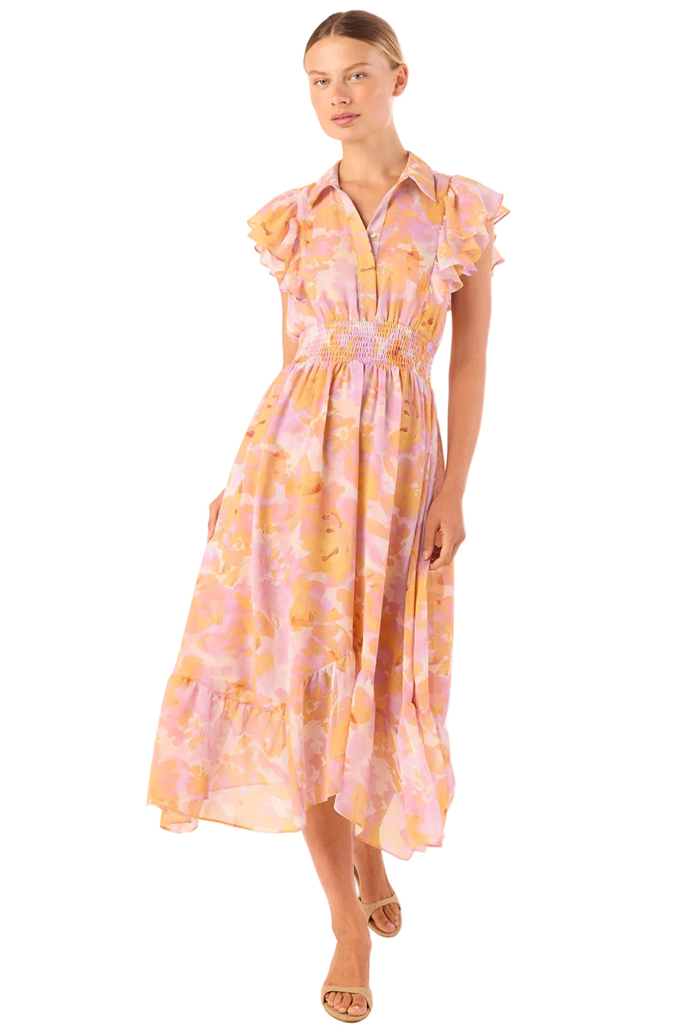 Woman wearing a yellow and pink patterned dress on a white background